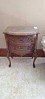 Full view of carved wooden nightstand showing overall design and size