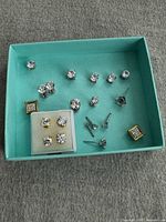 Overview of turquoise box with multiple moissanite stud earrings
