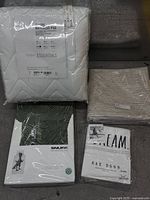 Group shot of four sealed bedding items