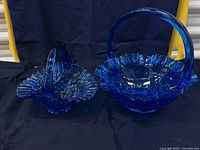 Both cobalt blue glass baskets side by side showing size difference
