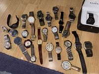 All watches laid out showing variety of styles, brands and conditions