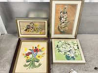 All four framed floral art pieces grouped together