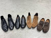 All four pairs lined up: black lace-ups, black loafers, tan Chelsea boots, brown derbies