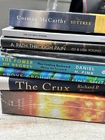 Stack of all seven books showing titles and formats