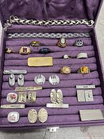 Overview showing bracelets, rings, tie bars and cufflinks in case