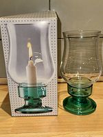 Assembled hurricane candle holder beside original box