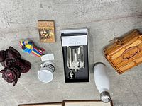 Flat lay of flask set, lion, donkey, mug, playing cards, booklet, bottle, basket
