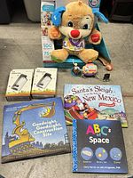 All items group shot showing plush puppy in box, Miniscope kits, books, figurines