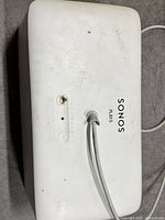 Rear/top view showing Play:5 branding, power cord, and surface wear