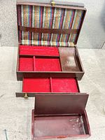 Lord Buxton jewelry case open showing red velvet compartments and removable drawer