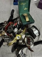 Pile of assorted wristwatches showing variety and Reliance boxed watch