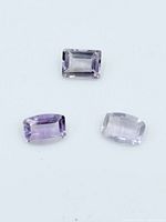 Three rectangular amethyst stones on white background