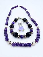 Full set laid out showing necklace, bracelet and earrings