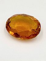 Front view of faceted oval citrine gemstone