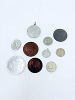 Overall view of ten coins and medallions on white background