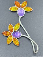 Front view showing amber petals and amethyst centers