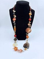 Full view of gemstone necklace on display bust