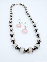 Necklace laid flat showing bead pattern and earrings