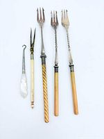 All five utensils laid out on white background