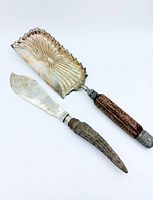 Full view of two sterling silver serving utensils with horn handles