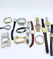 All thirteen women’s watches laid out showing variety of styles and finishes