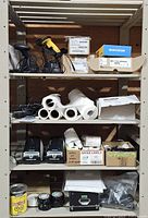 Full shelving unit showing barcode scanners, printers, label rolls and accessories