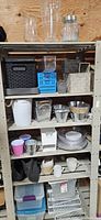Full shelving view showing baskets, glassware, bowls, drinkware and storage totes