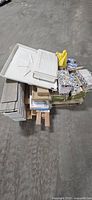 Pallet showing shower pan, flooring boxes, hardware, patterned mats