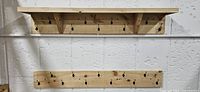 Both wooden coat racks mounted on wall, showing hooks and shelf
