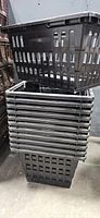 Front view of stacked black plastic shopping baskets