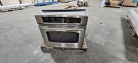 Front view of stainless wall oven on pallet