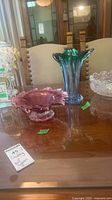 Cranberry bowl and art glass vase on table