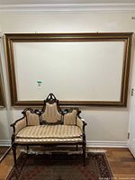 Full view of large rectangular frame on wall above settee