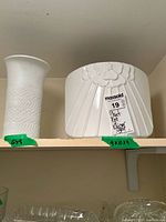 Plant pot and vase on shelf showing relative sizes