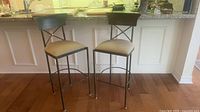 Both metal bar stools front view against counter