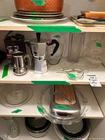 shelf view with espresso makers, jar, nut dish