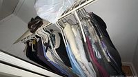 Closet rod with numerous women’s garments on hangers