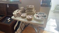 Overall view of stacked Coalport dinnerware on table