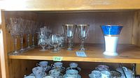 Shelf showing all stemware and Noritake vase