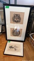 Large frame with two animal head prints and smaller framed dog print