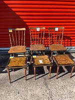 Front view of three spindle-back chairs and three marbled-top tables