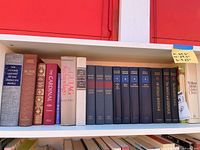 Top shelf showing history and literature hardcovers including Oxford History, Burr, The Cardinal, Gulag Archipelago and black classics set