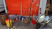 Group of garden tools, wheelbarrow, sprayers, long-handled tools