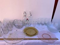 All items laid out on table, showing variety of glassware