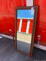 Front view of the rectangular mirror with brown frame