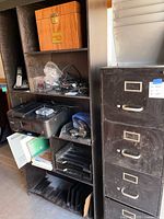 Bookshelf with electronics, file box, phone, printer, trays
