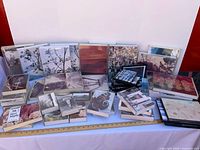 Wide shot of entire assortment of framed photographs on table