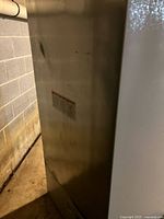 Side view of metallic exterior panel of refrigerator