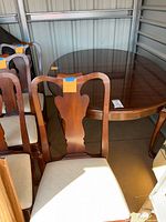 Dining table and several chairs showing finish and shape