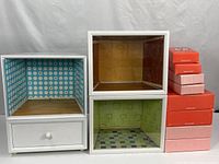 front view of four cabinets and seven American Girl boxes